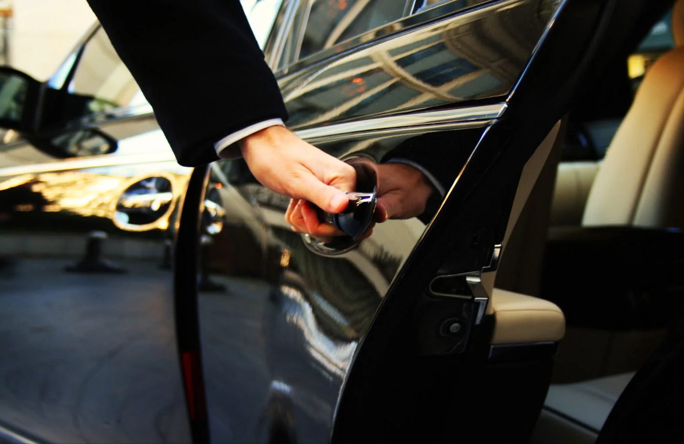 Chauffeur opening the car door for a client